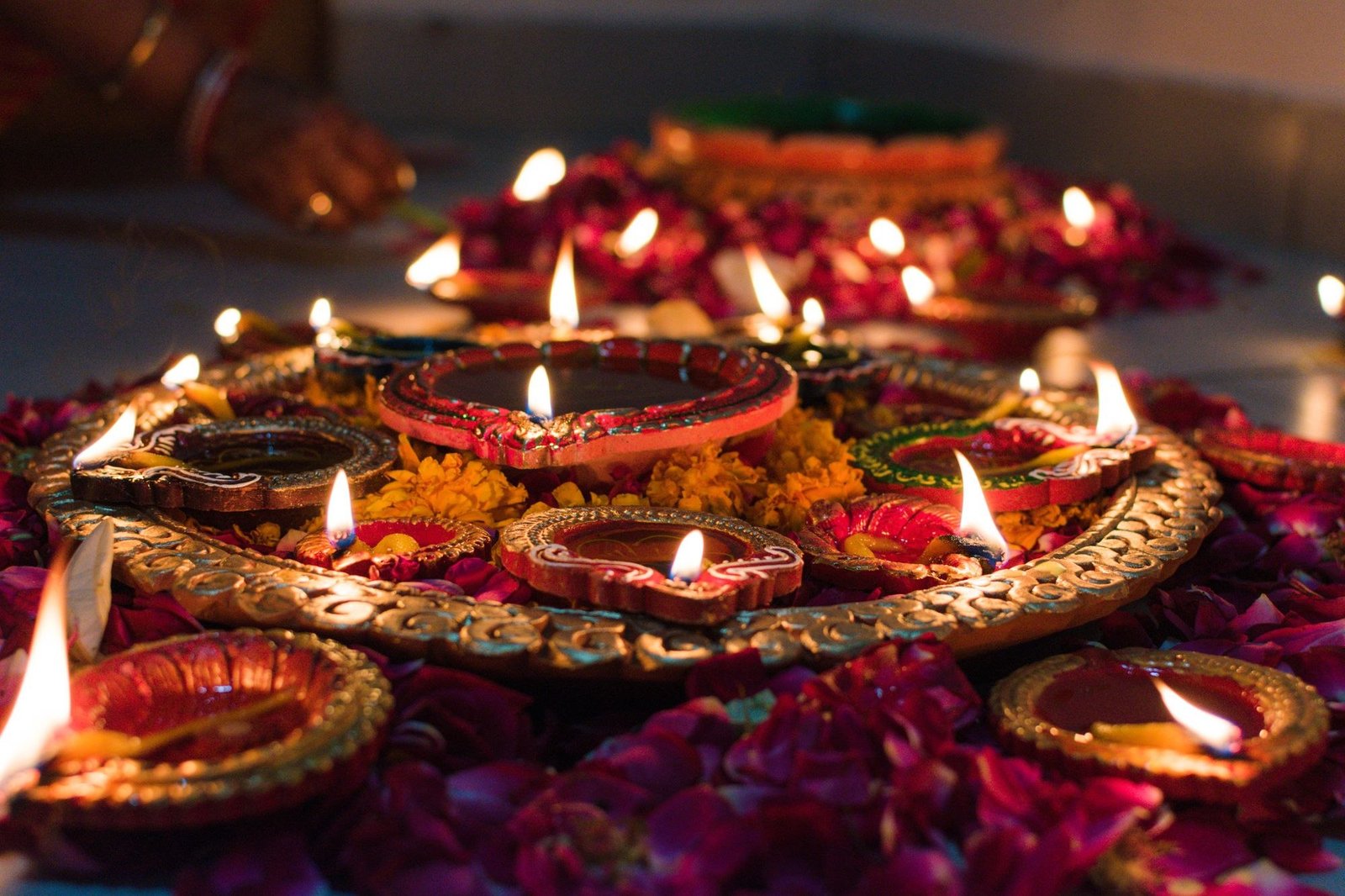 Traditional diyas surrounded by flowers